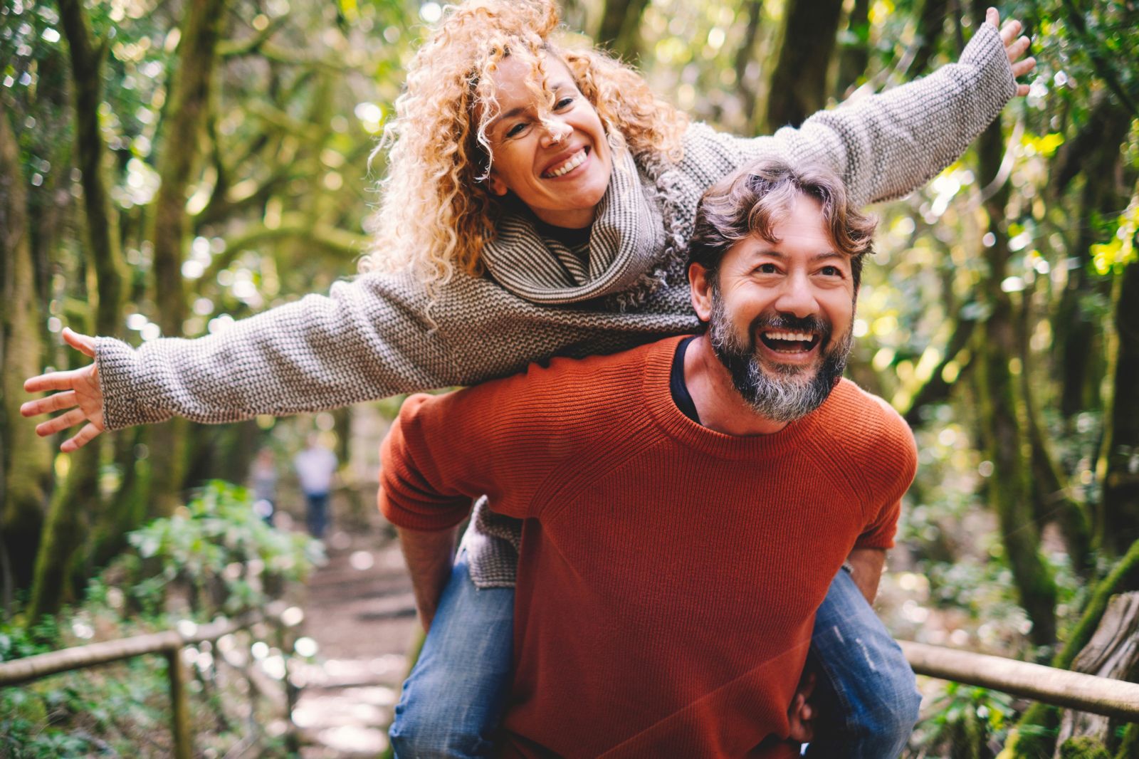 Women with grey shirt riding a man's back